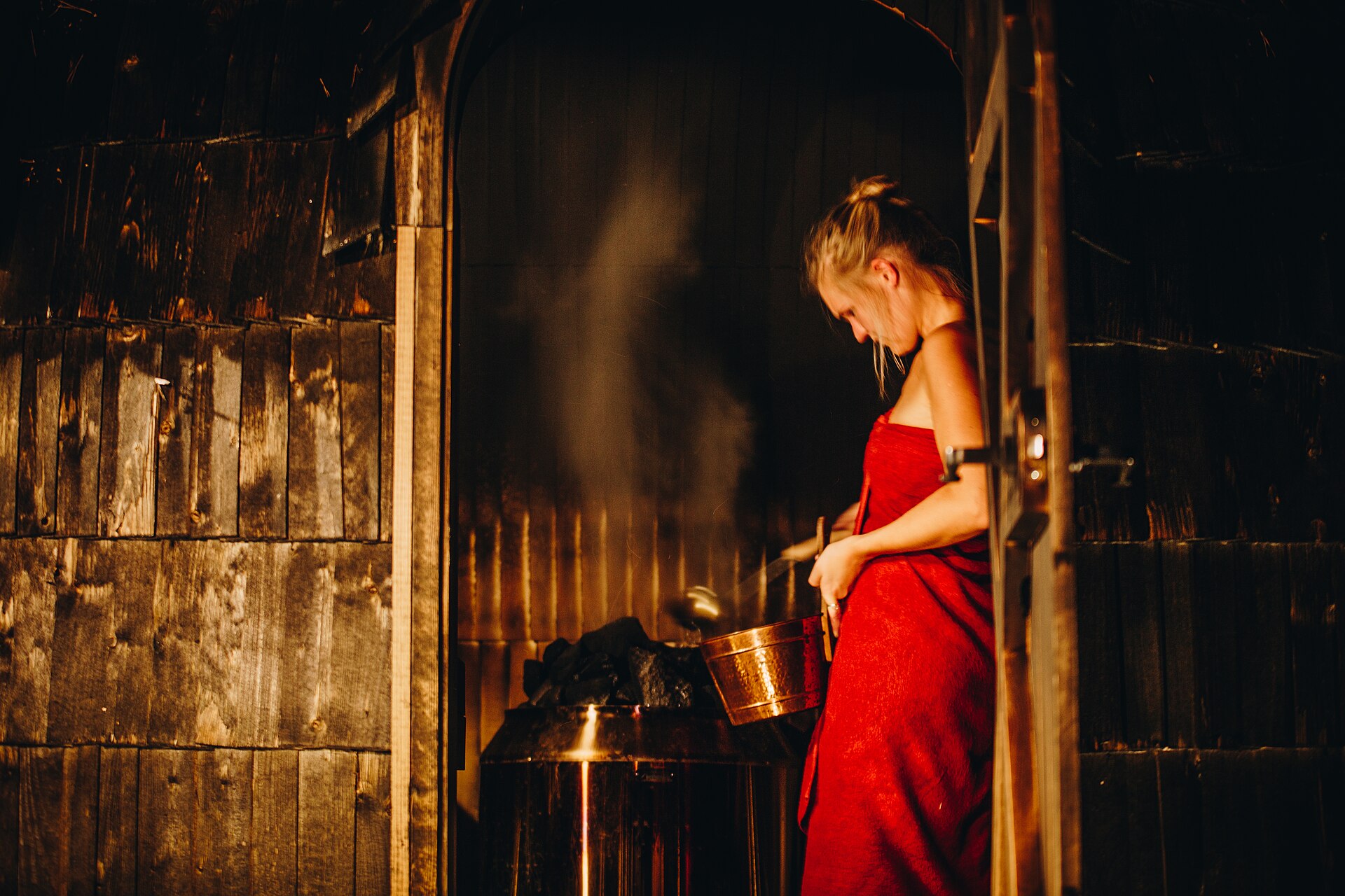 Water being poured over hot stones in an Estonian smoke sauna