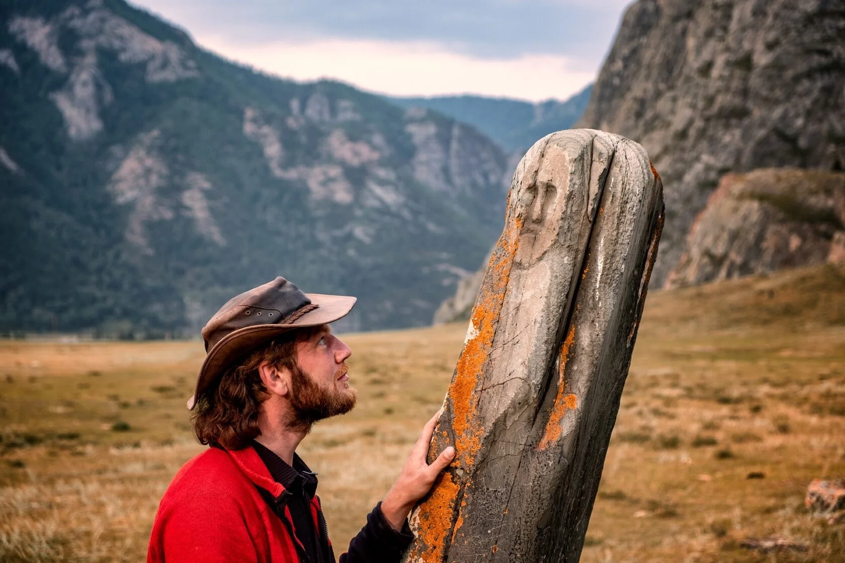 Alex beside an ancient stone monument in the Altai Mountains