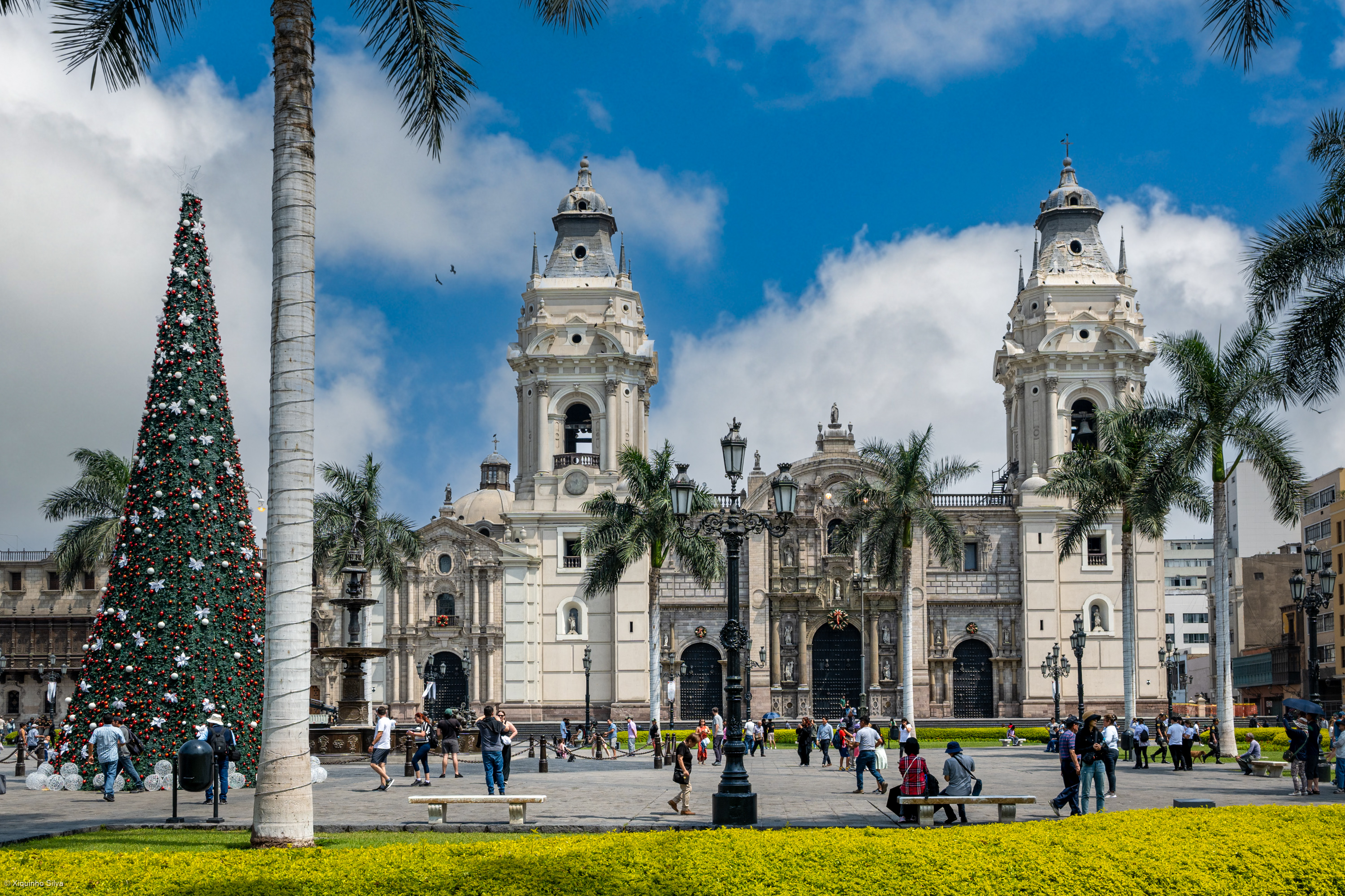 People crossing the Plaza Mayor in Lima's historic centre beneath the cathedral towers